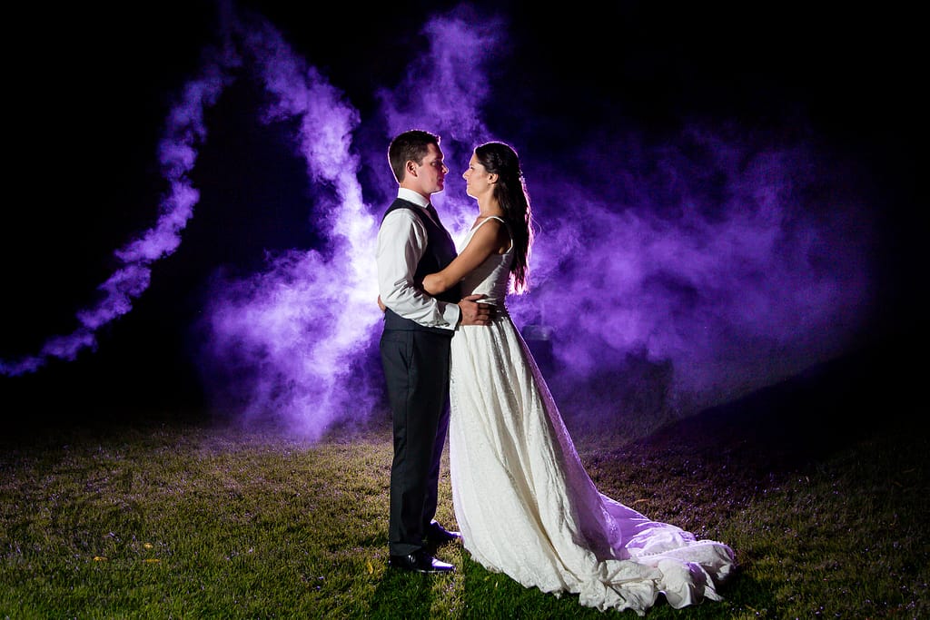 bride and groom with purple fog ontario