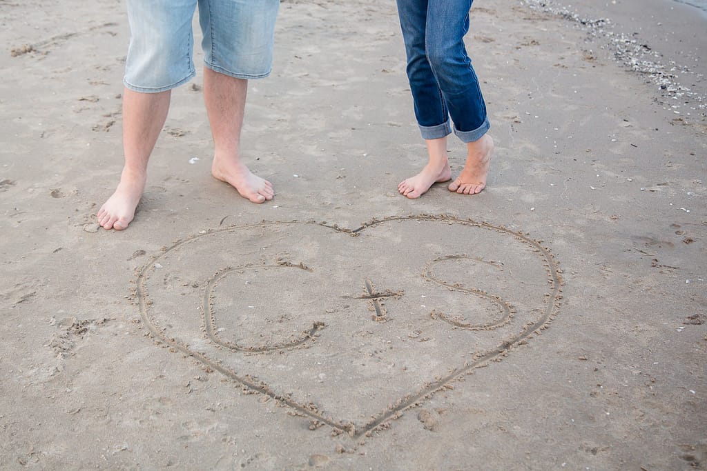 couples initials written in the sand in a heart port burwell engagement photography by london ontario photographer Woodgate Photography