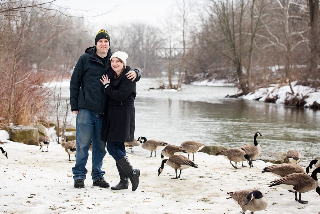 engaged couple hugging with candian geese london ontario engagement photography